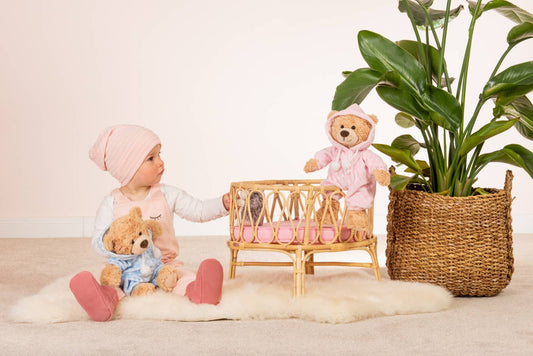 Plush teddy bear in pink pajamas
